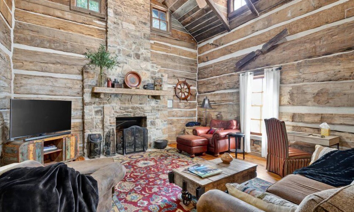 Guntersville Cabin | Historic lakefront log cabin on Lake Guntersville, restored from two pre-Civil War cabins. Sleeps 20 with 4BR/5BA, loft bunks, designer finishes, modern comforts, and steps to swimming, fishing & boating.