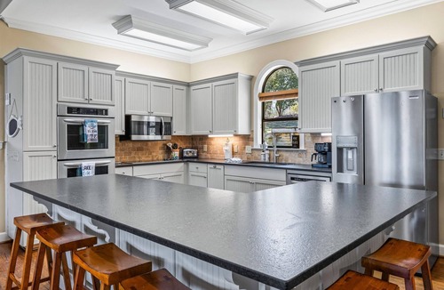 Little Kowaliga House | Escape to this stunning 6 bed, 5 bath lakefront home, perfect for large groups & family getaways. With space to sleep up to 20 guests, this home features expansive indoor living areas & breathtaking lake views throughout.