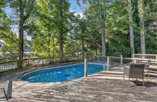 Guntersville Cabin | Historic lakefront log cabin on Lake Guntersville, restored from two pre-Civil War cabins. Sleeps 20 with 4BR/5BA, loft bunks, designer finishes, modern comforts, and steps to swimming, fishing & boating.