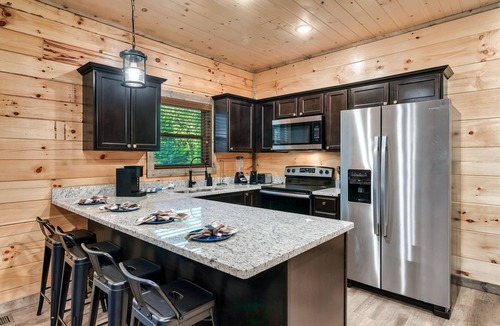 Sevierville Cabin | Modern Cabin with Hot Tub, Air Hockey, King Beds, Grill and Outdoor Pool!