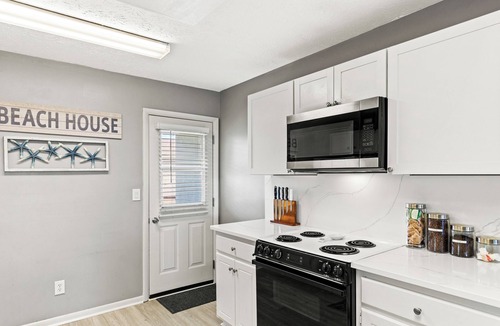 West Panama City Beach Condo | Walk to Beach 2BR Sleeps 7 Pool + Beach Gear