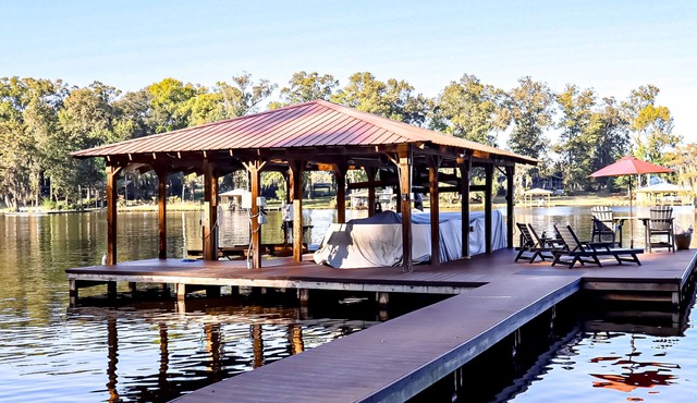 Colorful lakefront home with private dock, scenic porch, washer/dryer, & AC
