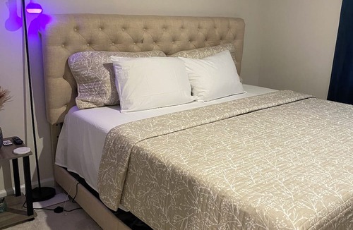 Milford House | Primary bedroom and private bathroom space. Shared kitchen and dining area